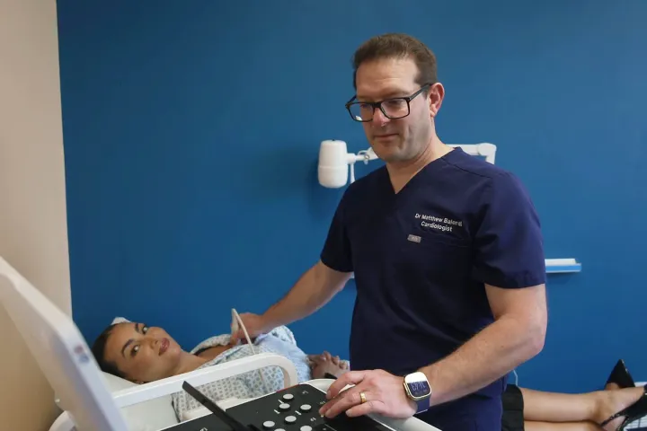 Dr. Matthew Balerdi performing an echocardiogram on a patient