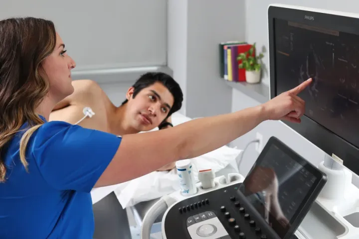 A sonographer reviews an ultrasound image during an examination